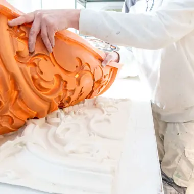 Student die een mal gebruikt voor het maken van gedetailleerde decoratieve afwerking bij afbouw en onderhoud